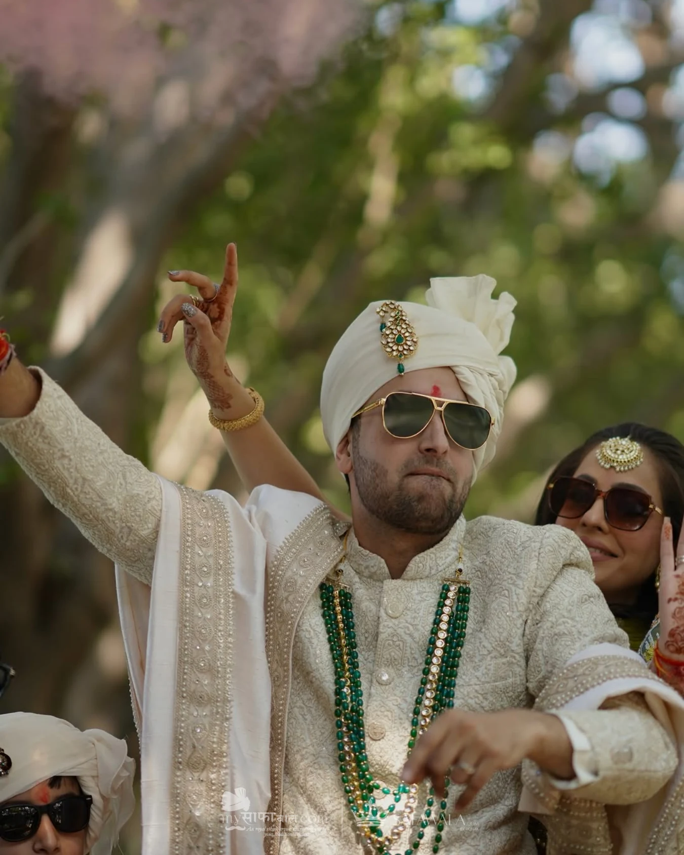 Groom in an ivory wedding safa with emerald jewellery for Bel Air